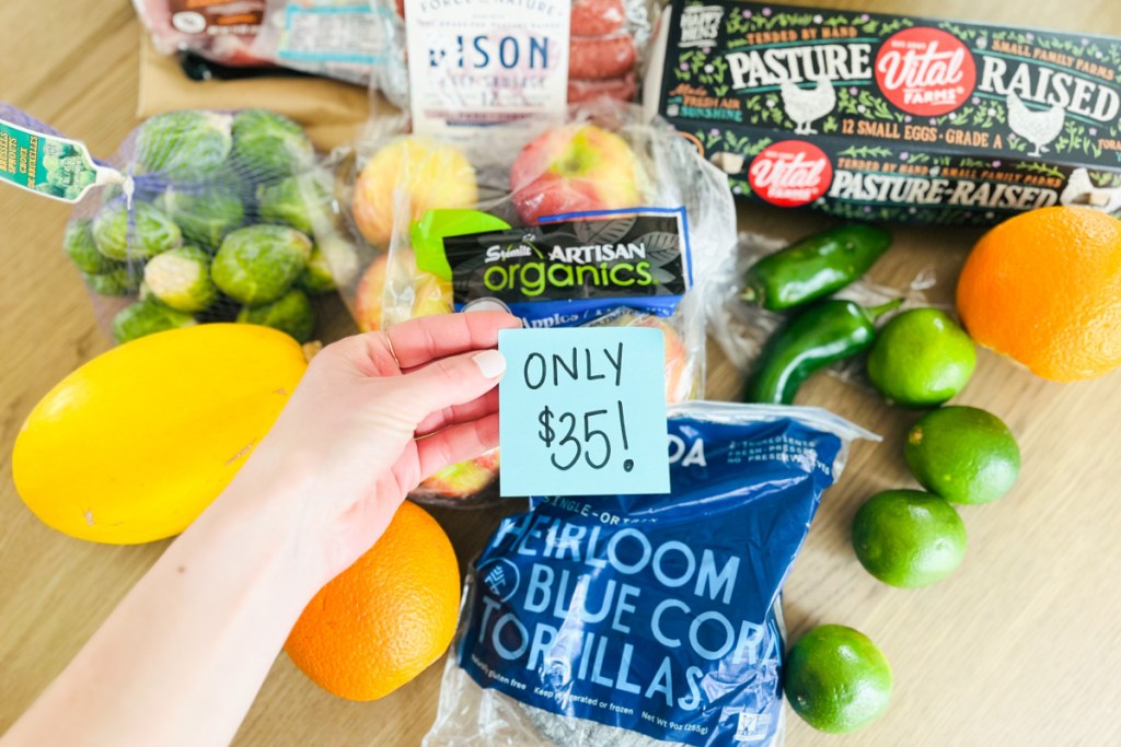 hand holding sticky note over fresh produce