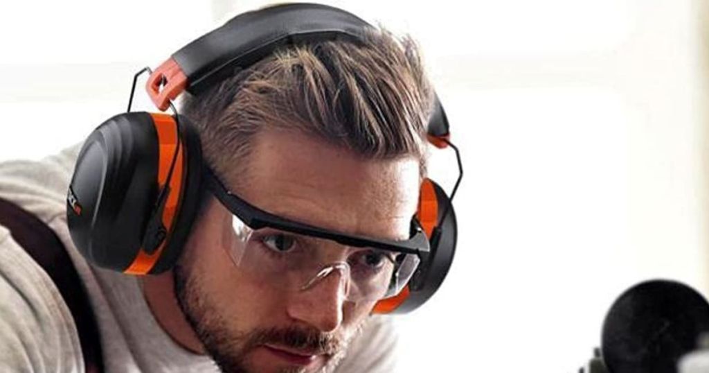 man wearing protective black and orange earmuffs