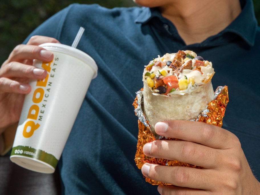 man holding burrito and fountain soda