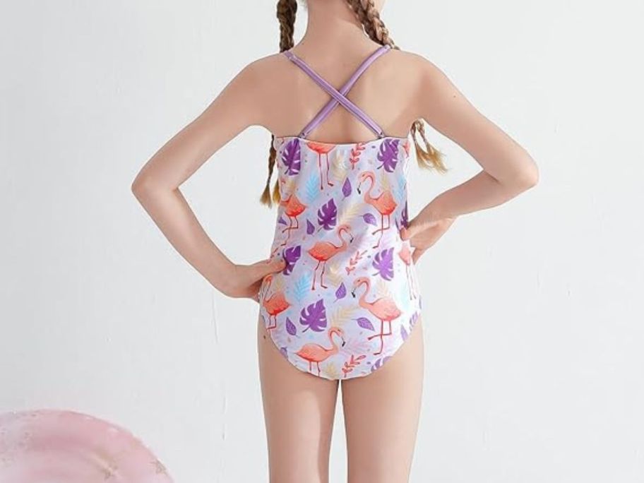 girl wearing swimsuit with flamingos on it