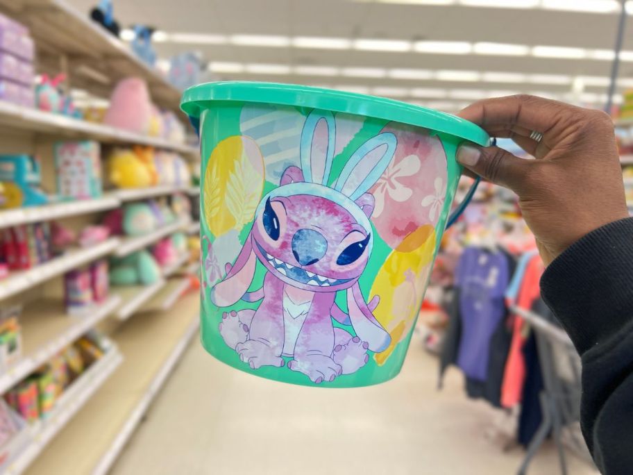 hand holding a green Disney Angel from Lilo & Stitch Plastic Easter Bucket 