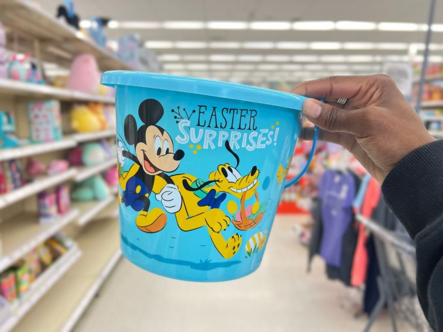 hand holding a blue Disney Mickey & Pluto Plastic Easter Bucket 