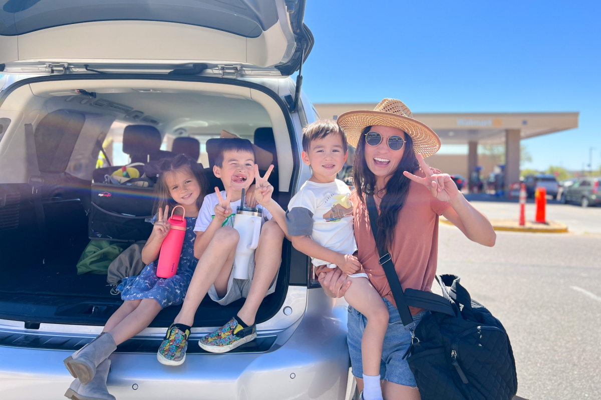 family behind SUV trunk at walmart gas station