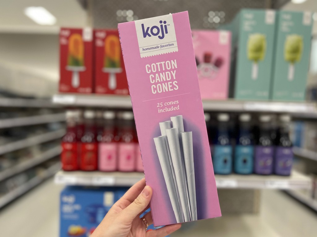 woman holding box of Koji Cotton Candy Wands 25 Packs in hand