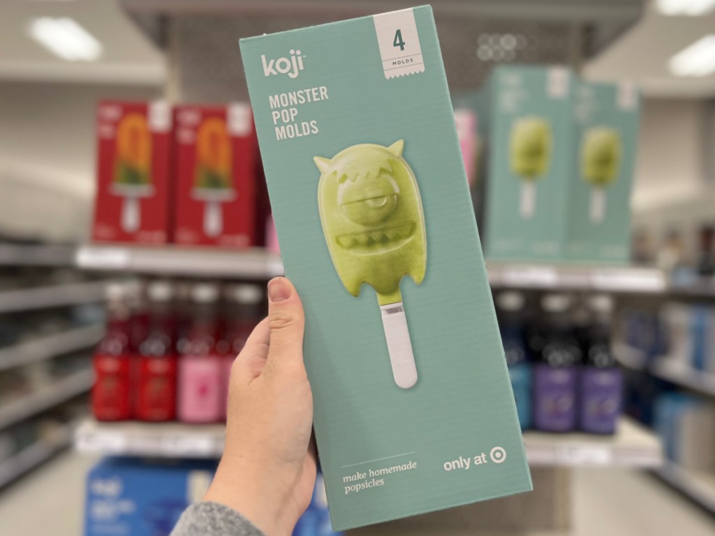 woman holding box of Koji Monster Ice Pop Mold in hand