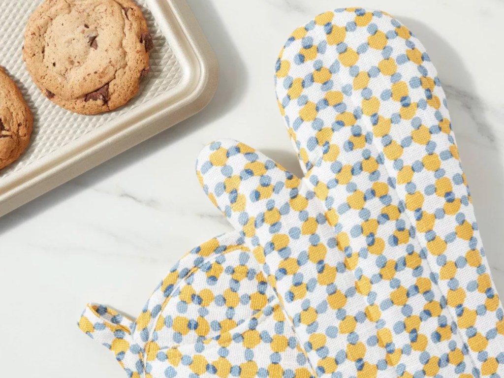 yellow and gray pot holders next to pan of cookies