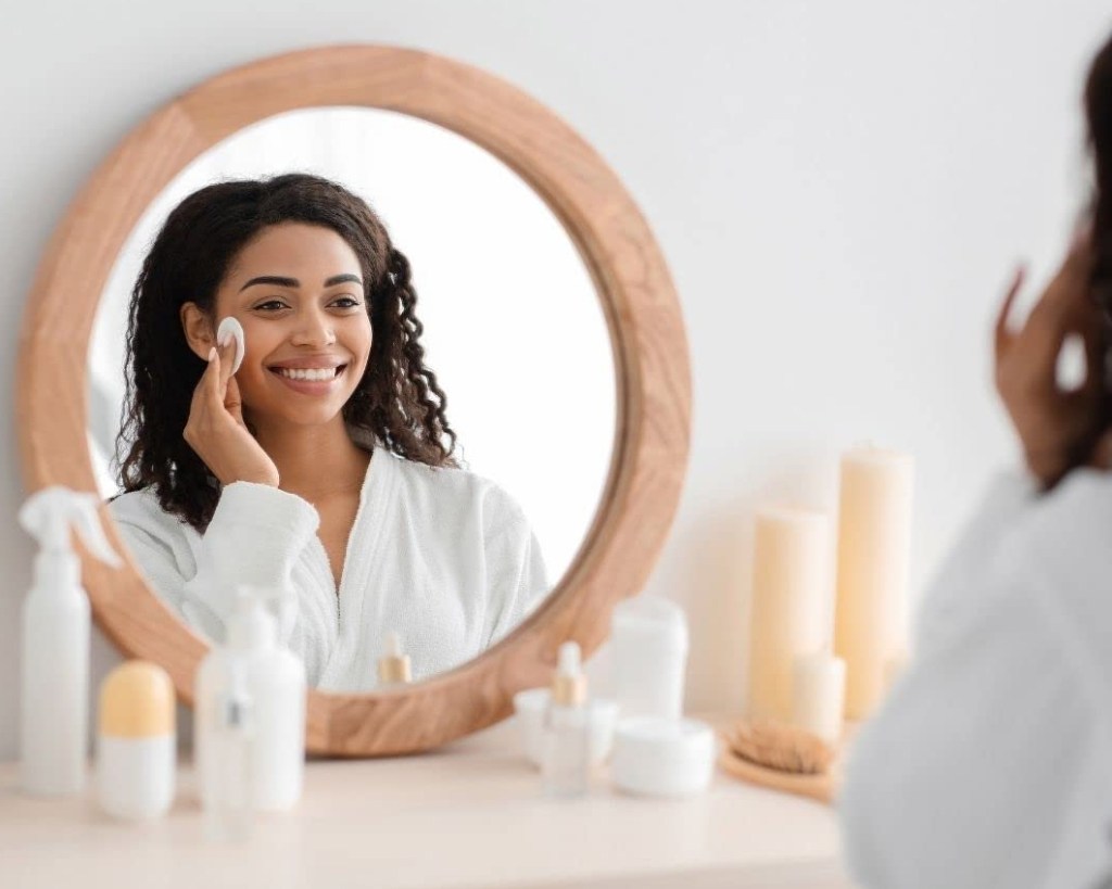 Woman using a cotton round on her face