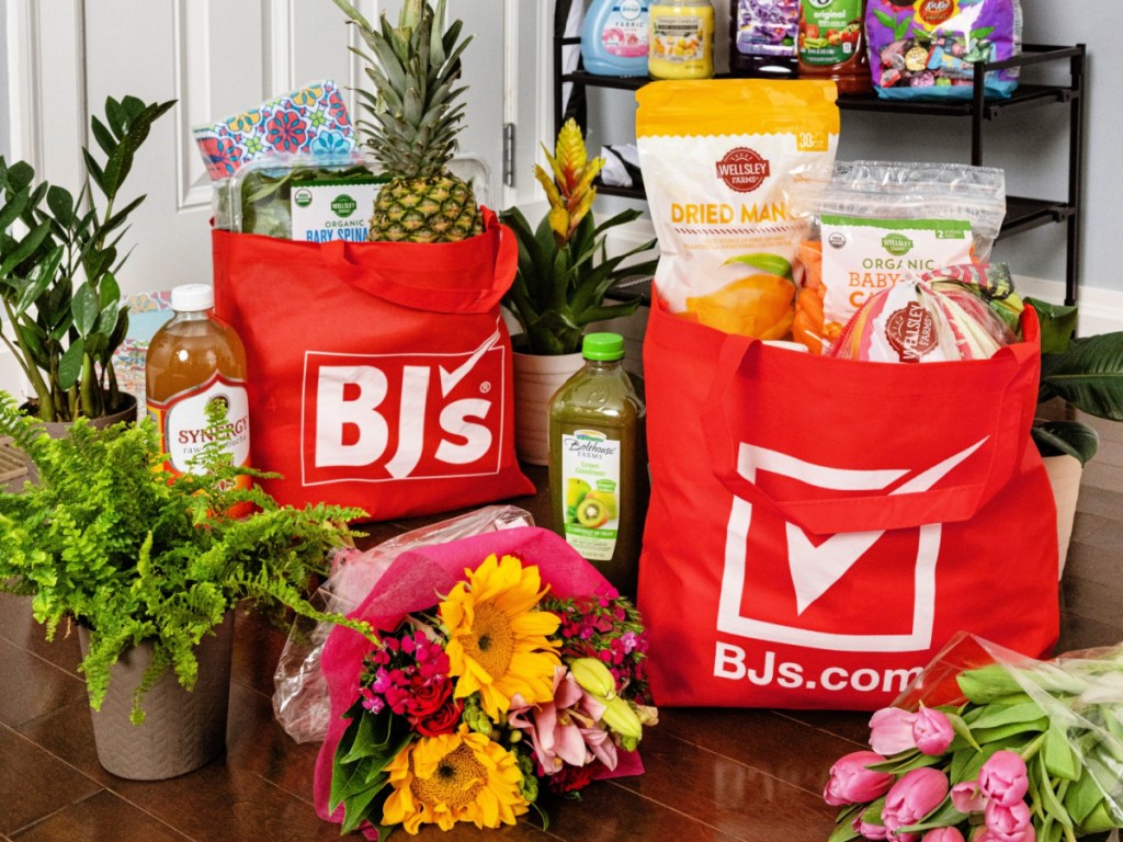 BJ's shopping bags full of groceries and various flowers and plants