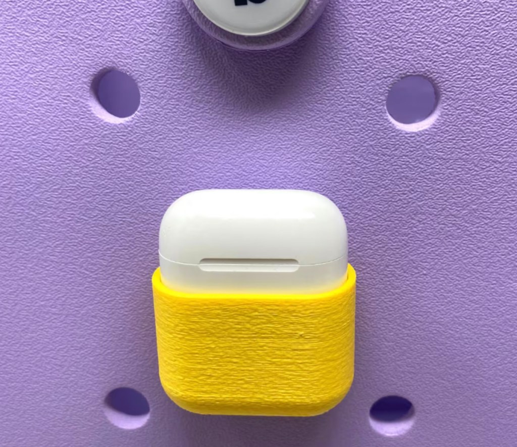 yellow airpod holder case on purple bogg bag