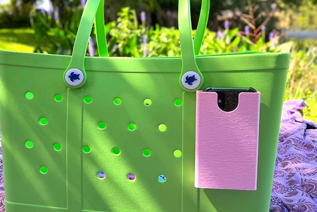 pink phone case on green rubber beach tote