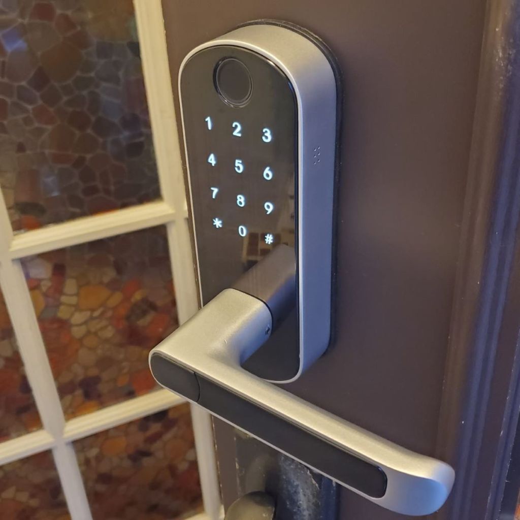 Silver and black smart lock on a door