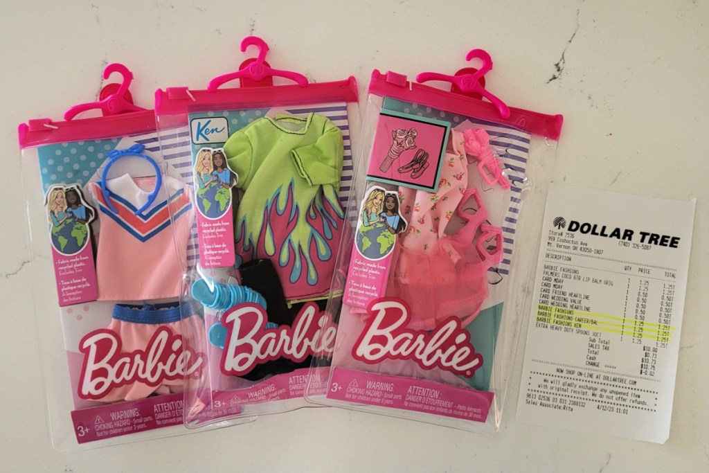 Barbie outfits next to a dollar tree receipt