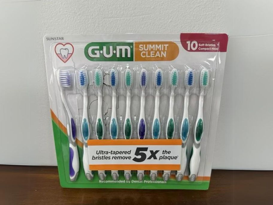 GUM Summit Toothbrush, 10-pack leaning against wall