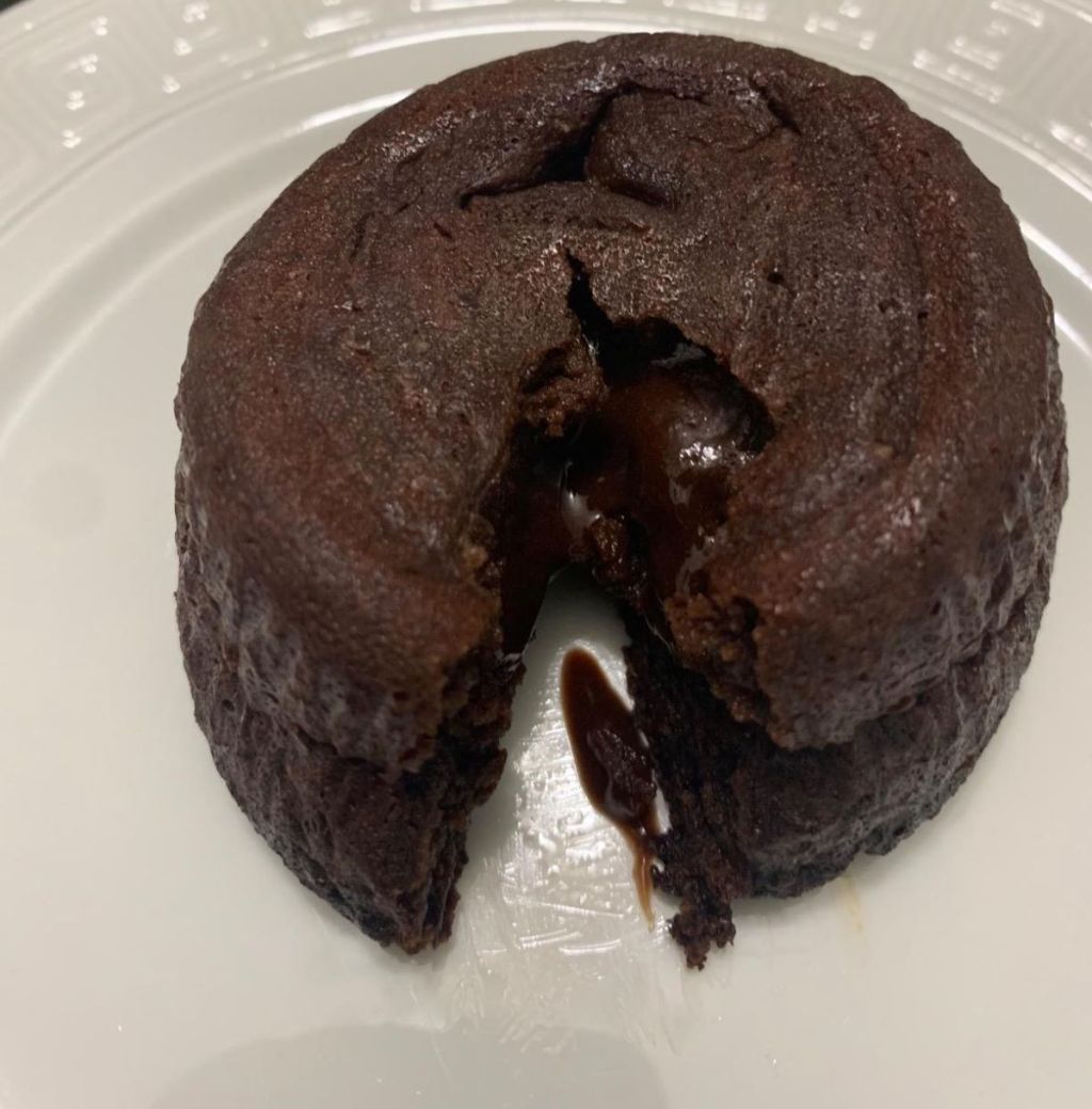 Lava cake on a plate with a piece cut out