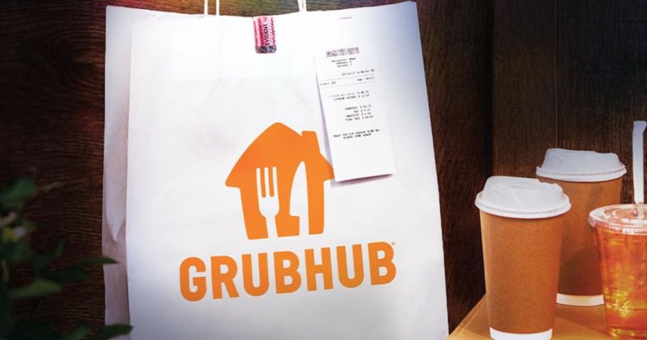 A grubhub delivery bag with a receipt stapled to it next to a bunch of drinks in takeout cups