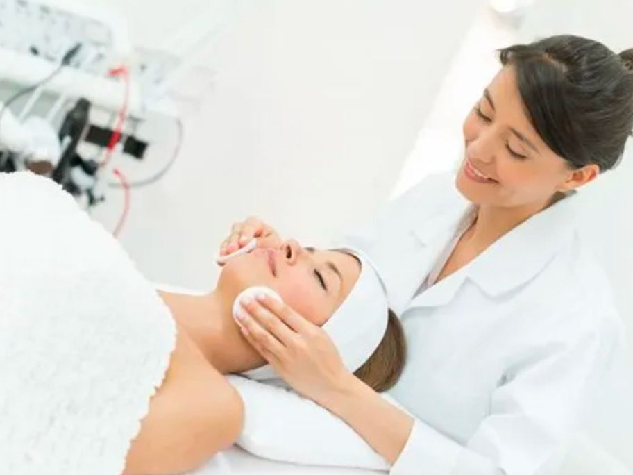 woman receiving a facial at a spa