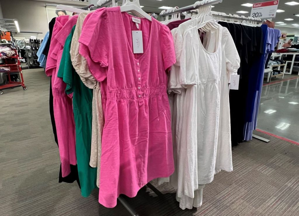 Pink and white dresses on hangers at Target