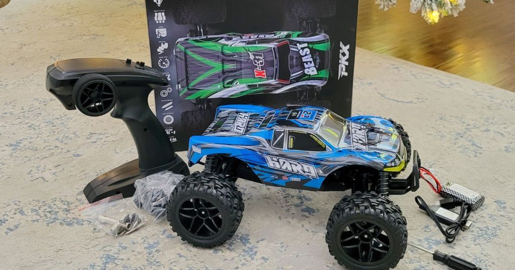 blue RC truck and remote with box on carpet