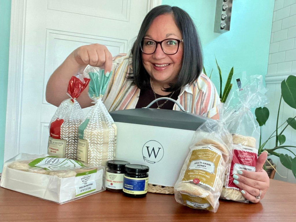 woman showing wolfermans breadbox tin and english muffins