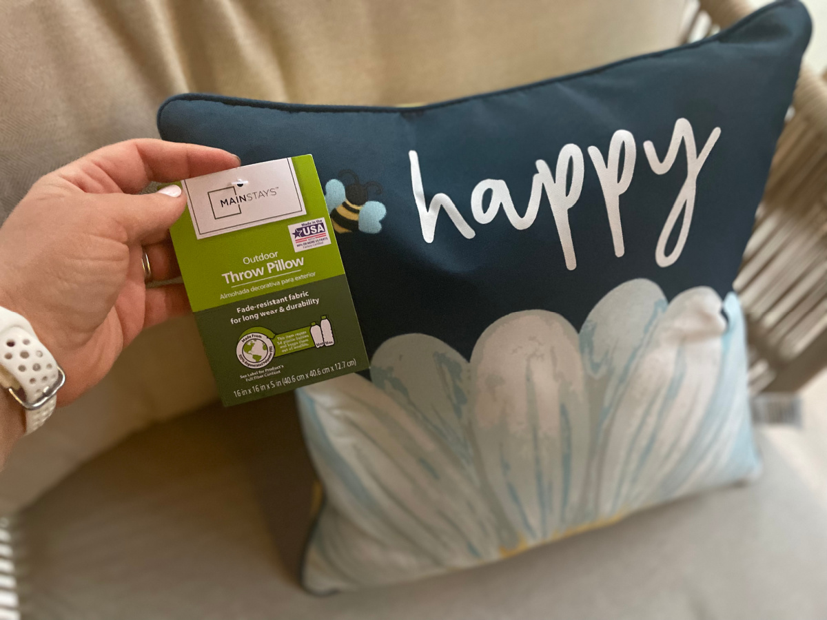 A "Be Happy" outdoor throw pillow which is one of the Hip2Save team's favorite pieces of Walmart outdoor decor