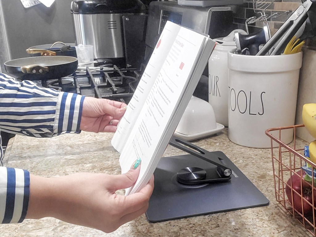recipe book on a laptop stand on kitchen counter