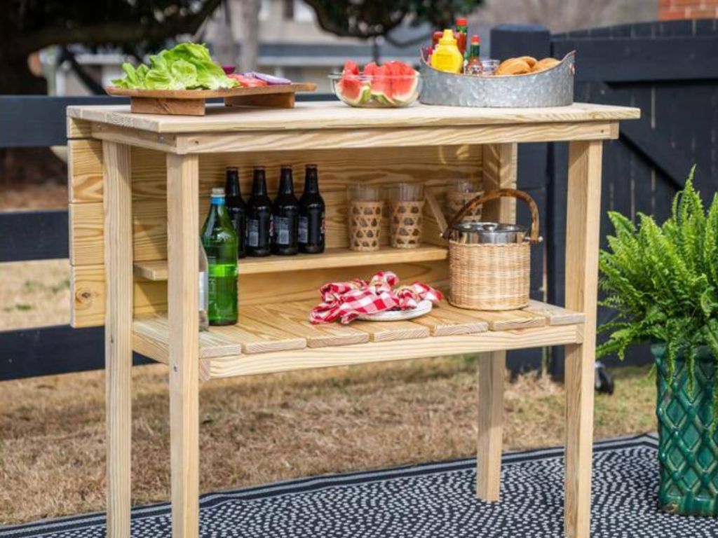 Wooden table with food and drinks on it