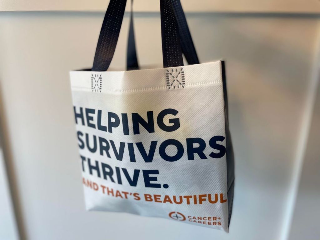 A reusable tote bag that says Helping Survivors Thrive
