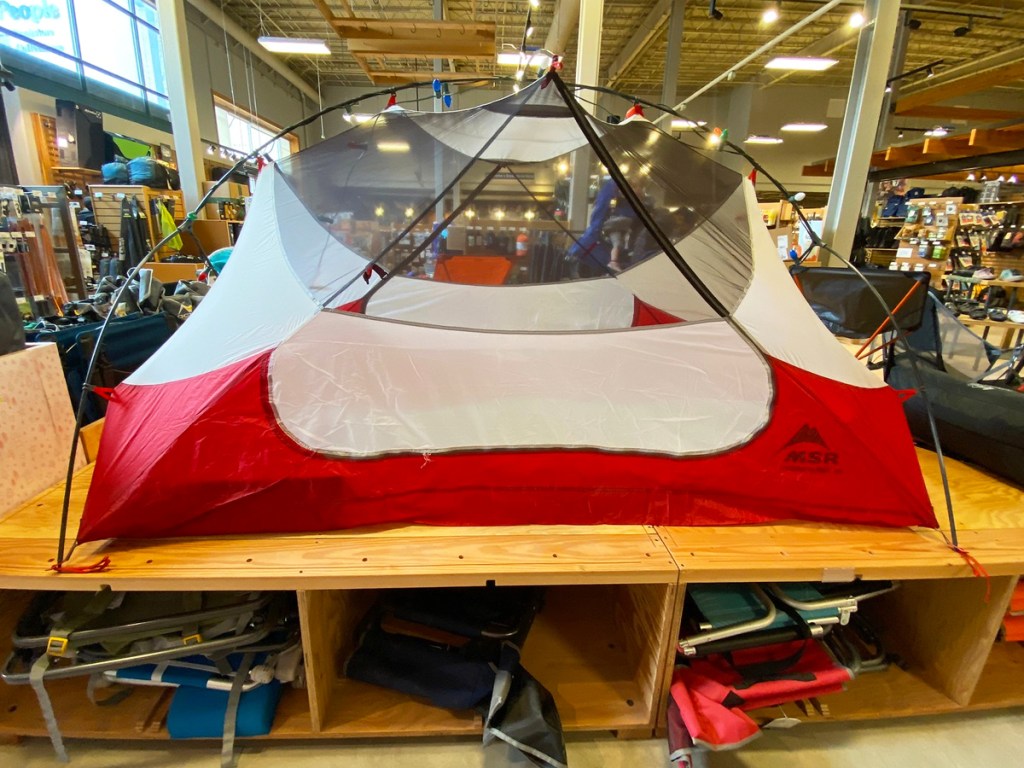 red and white tent on display in REI store