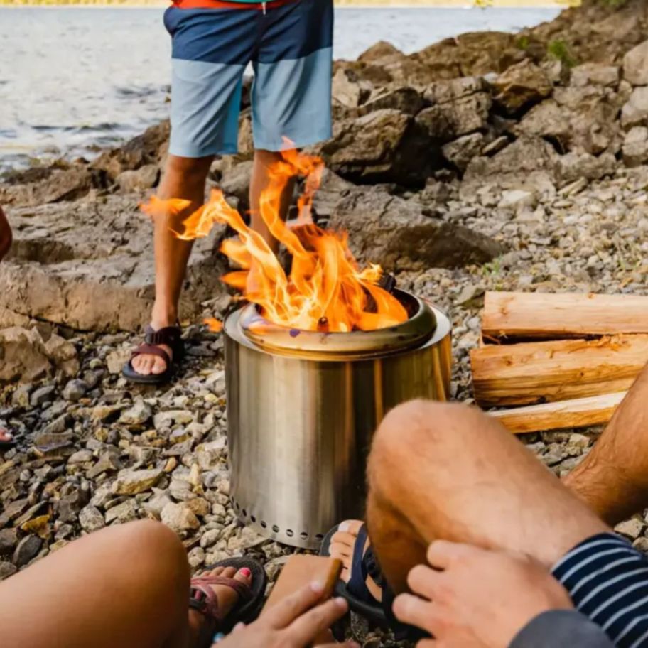 3 people gathered around a ranger solo stove