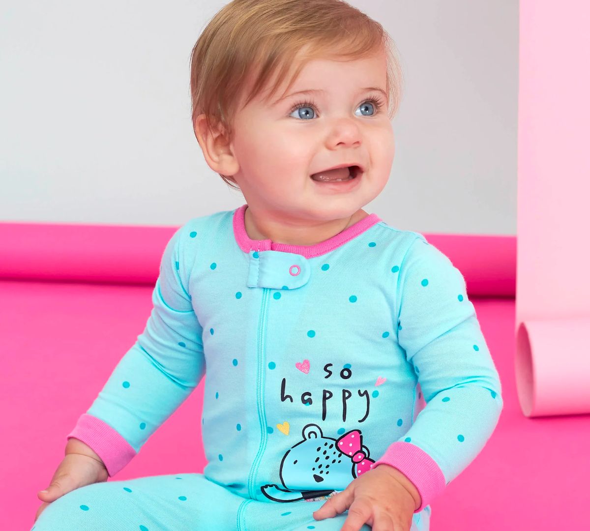 a baby girl wearing a lite blue Sleep n play onesie