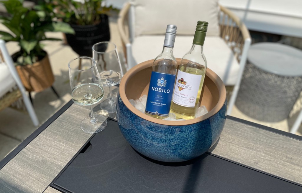 Wine bottles chilling in an outdoor planter filled with ice