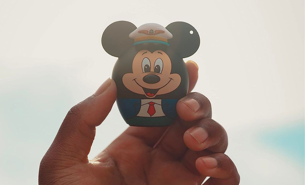 a hand holding up a bitty boomer mickey mouse