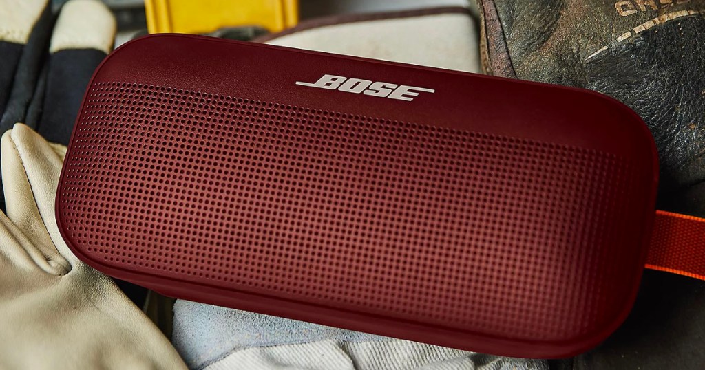maroon bose bluetooth speaker laying on table