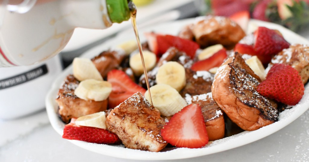Hawaiian roll french toast on a plate with fruit 