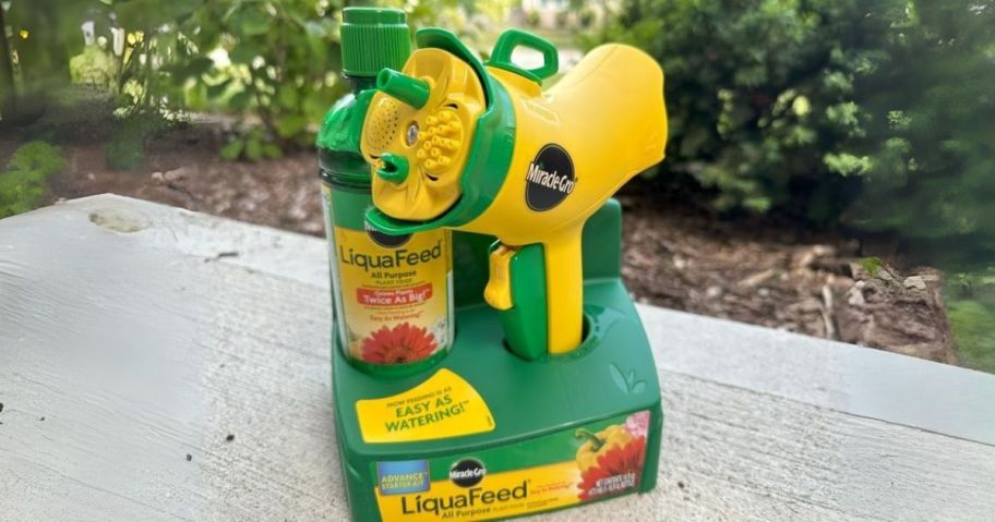 Miracle-Gro LiquaFeed All Purpose Plant Food Advance Starter Kit on table in yard