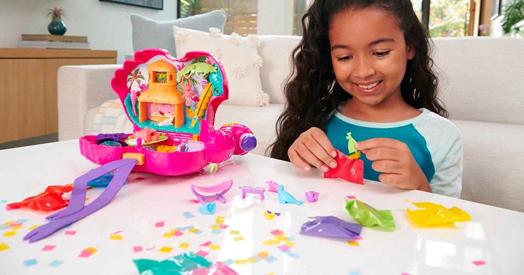 girl playing with polly pocket flamingo playset