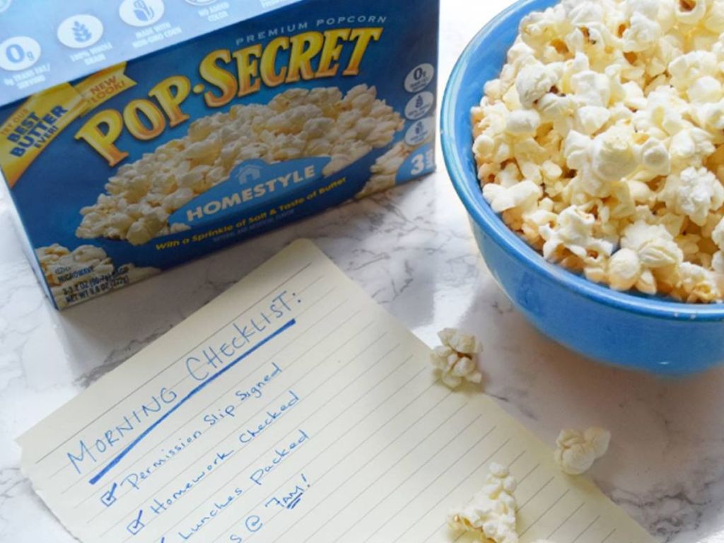 pop secret homestyle popcorn box next to morning checklist and bowl of popped popcorn