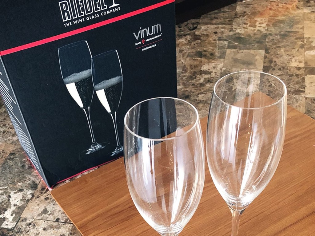 2 champagne flutes in front of their box