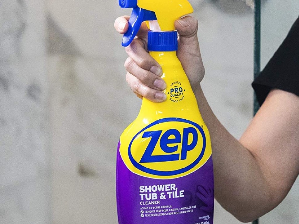 woman spraying Zep shower cleaner in her bathroom