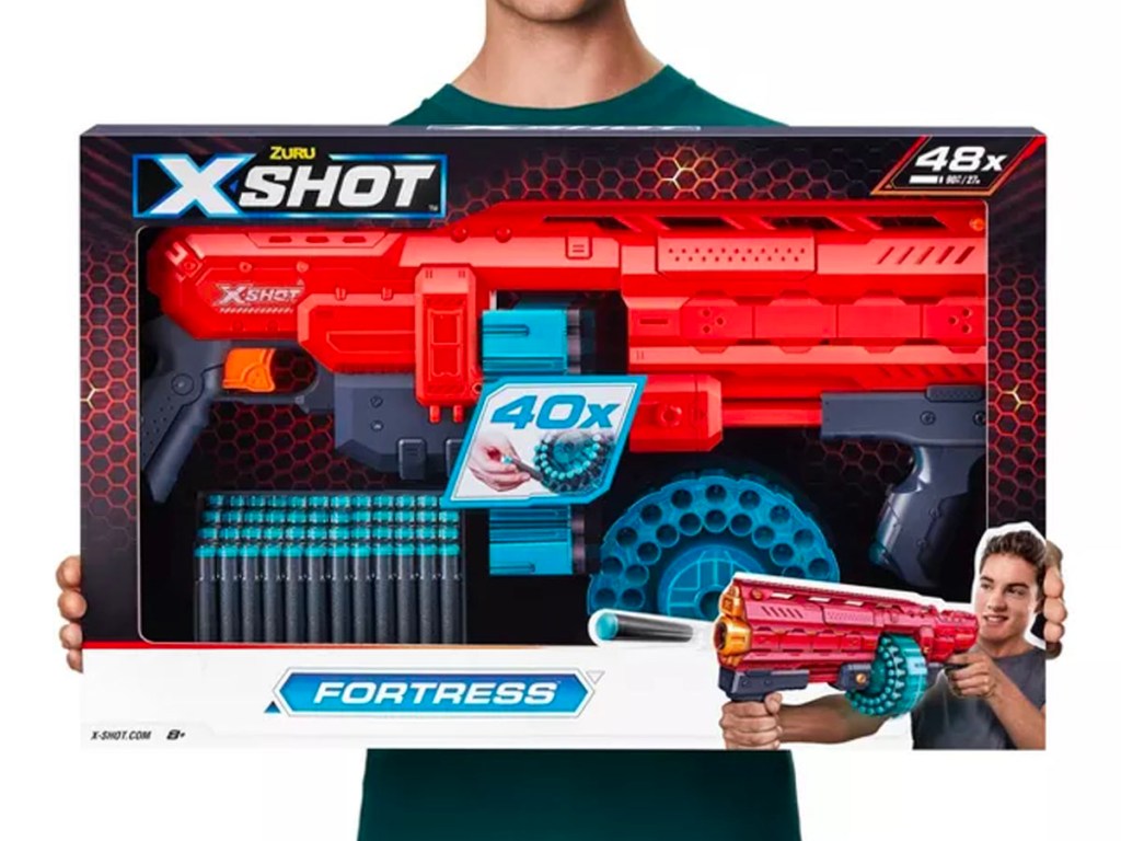 kid holding x shot toy blaster gun
