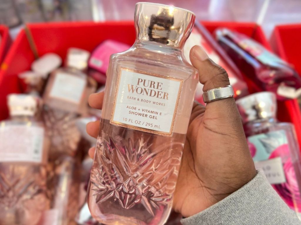 Hand holding s bottle of Pure Wonder Shower Gel at Bath & Body Works