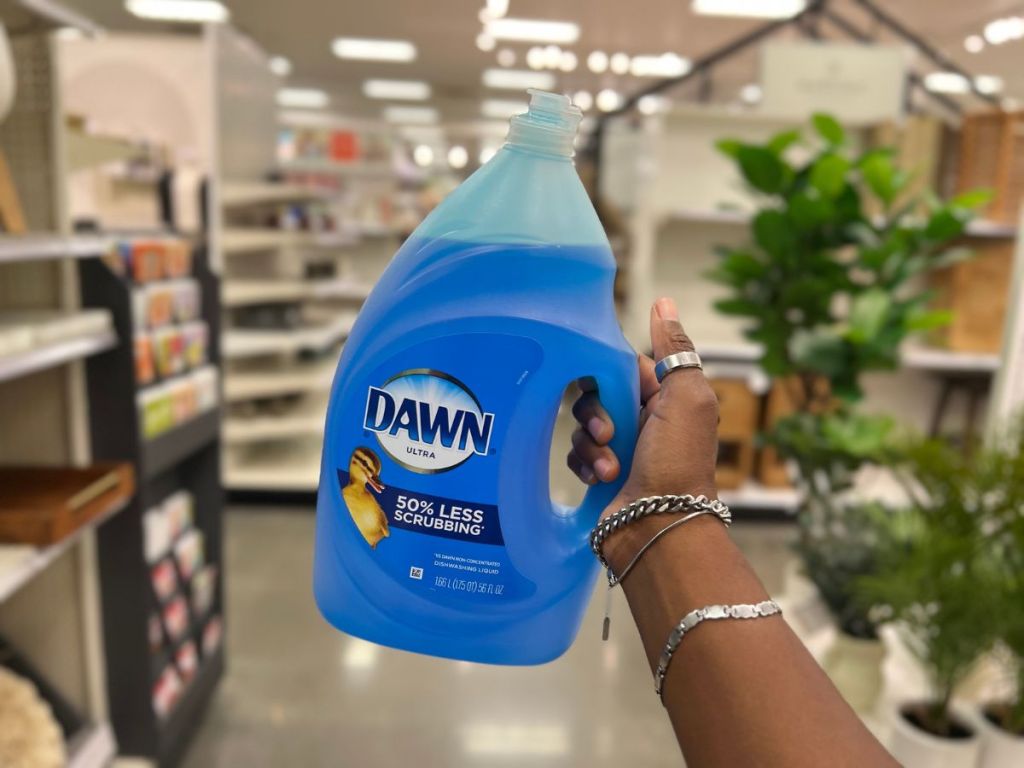 a hand holding a large bottle of Dawn Ultra