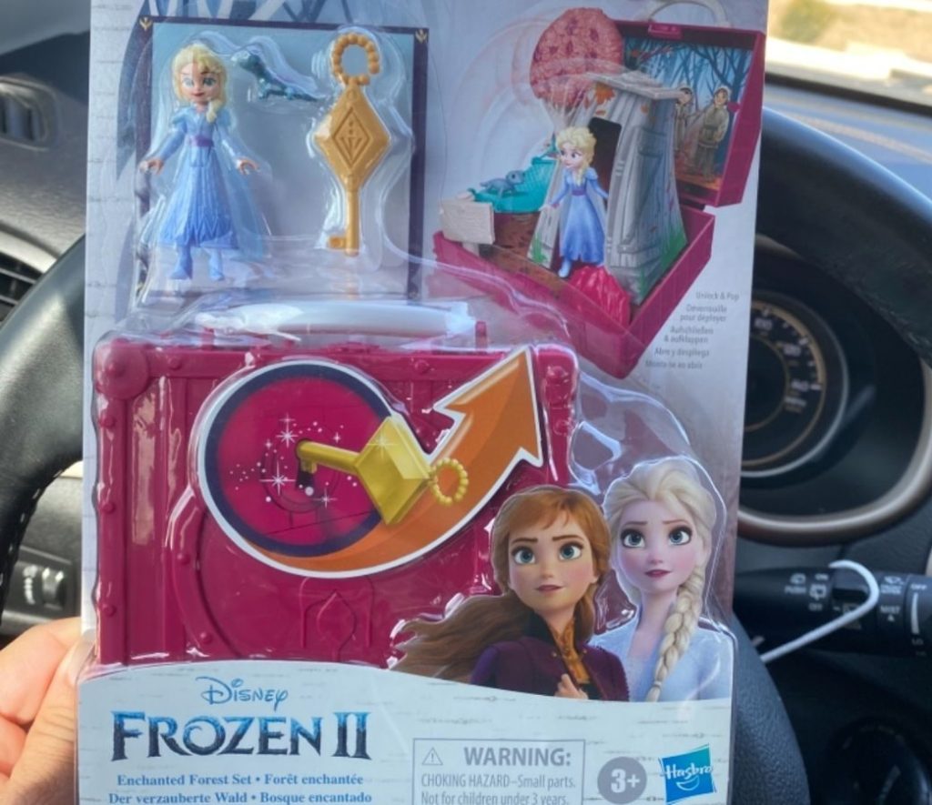 hand holding up a Disney Frozen Hasbro Pop Adventures Enchanted Forest Set Pop-Up Playset in the packaging