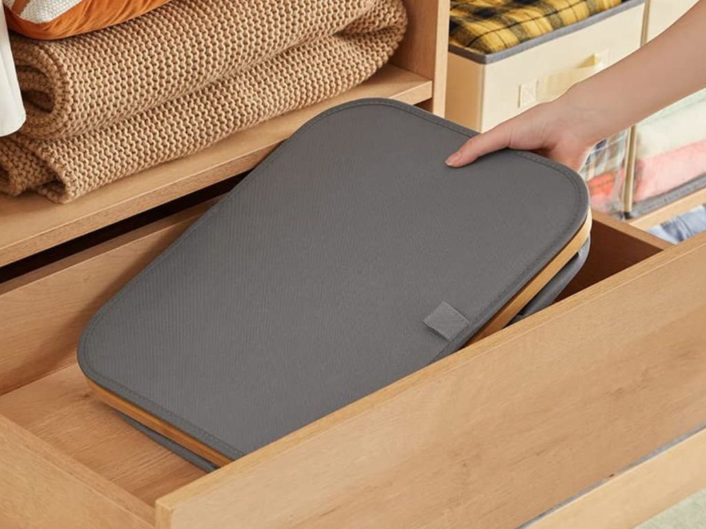 A laundry hamper folded up and put in a drawer