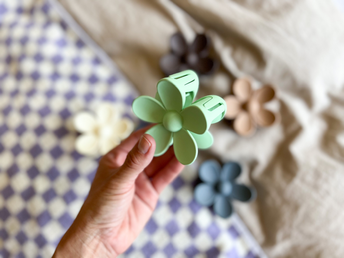 woman holding up Green Flower Hair Clip