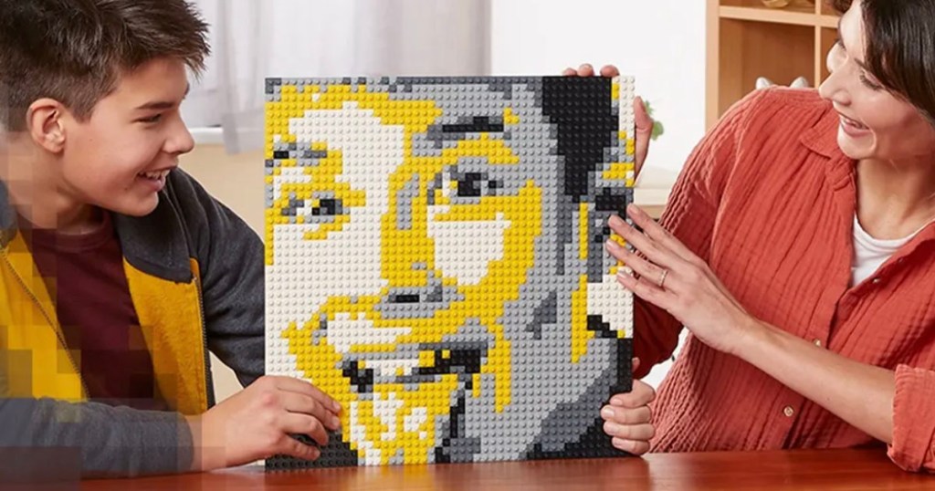 son and mom holding lego mosiac maker with picture of kid on it