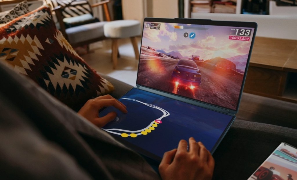 Person playing a racing game on a Lenovo laptop