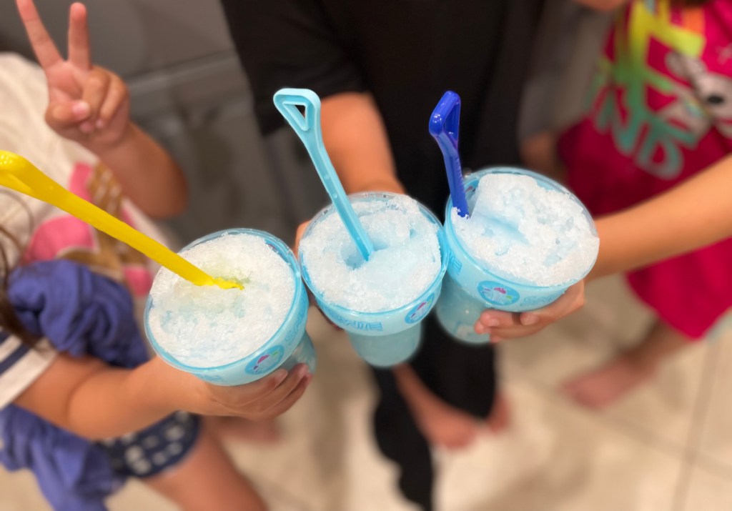 kids holding plastic cups full of shaved ice