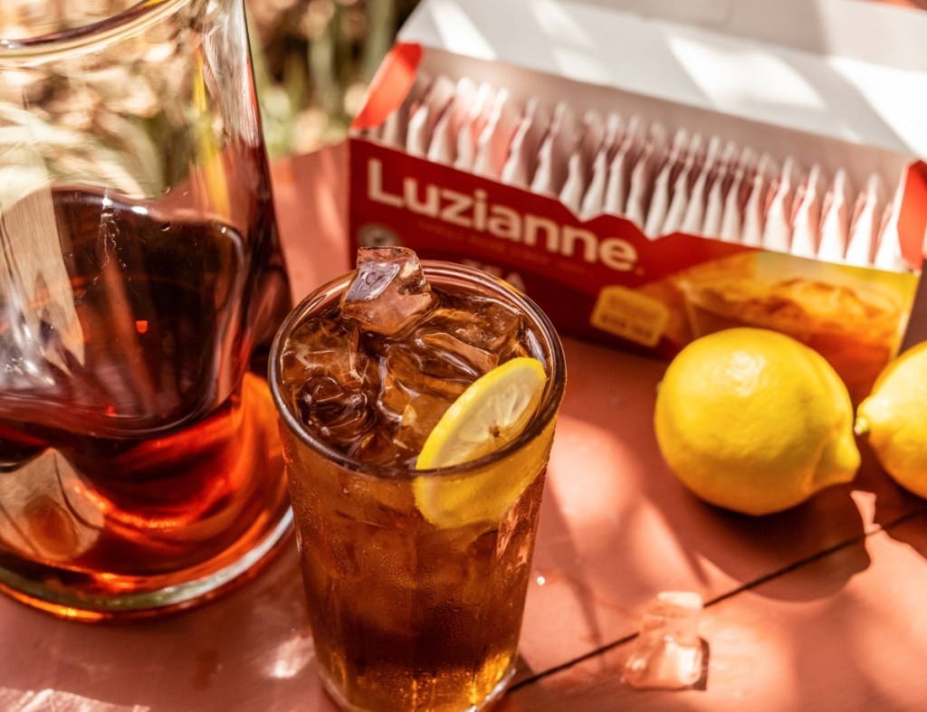 Iced tea in a glass and box of tea bags behind it