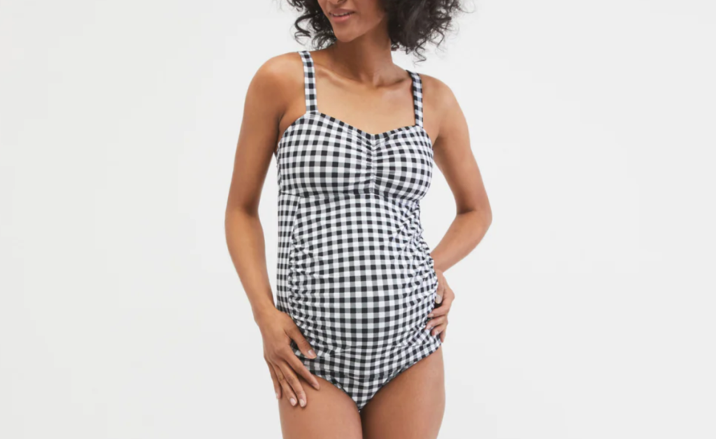 woman modeling a black and white gingham Motherhood Maternity Swimsuit